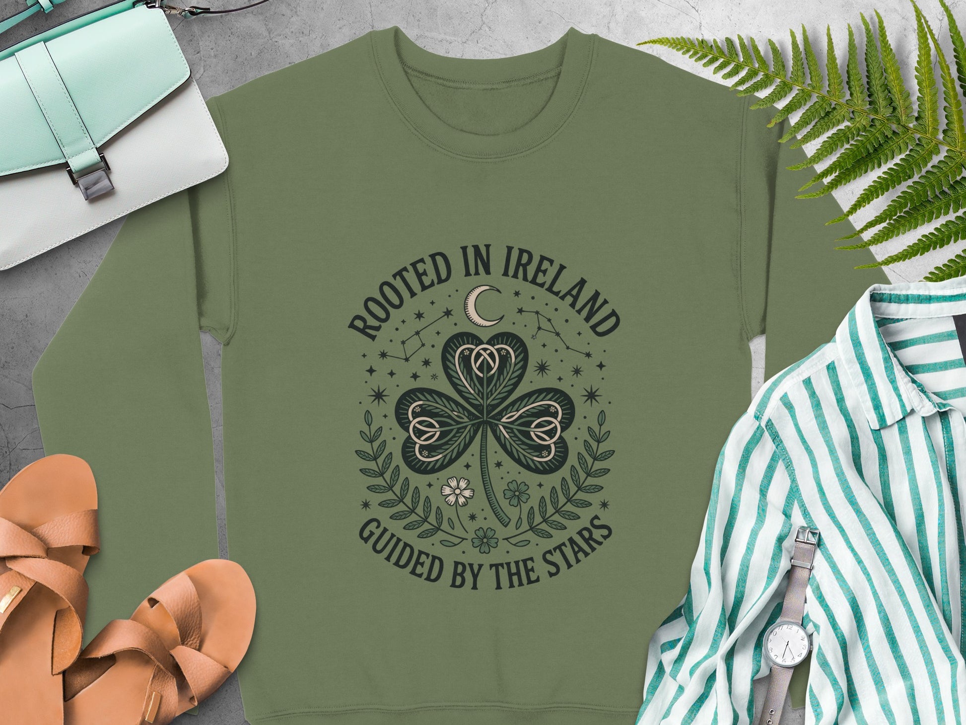 "Rooted in Ireland Guided by the Stars" text and shamrock design on Military Green sweatshirt