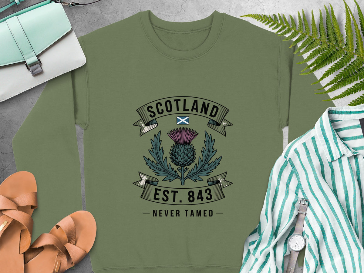 Olive sweatshirt with Scotland thistle graphic, "Est. 843 Never Tamed."