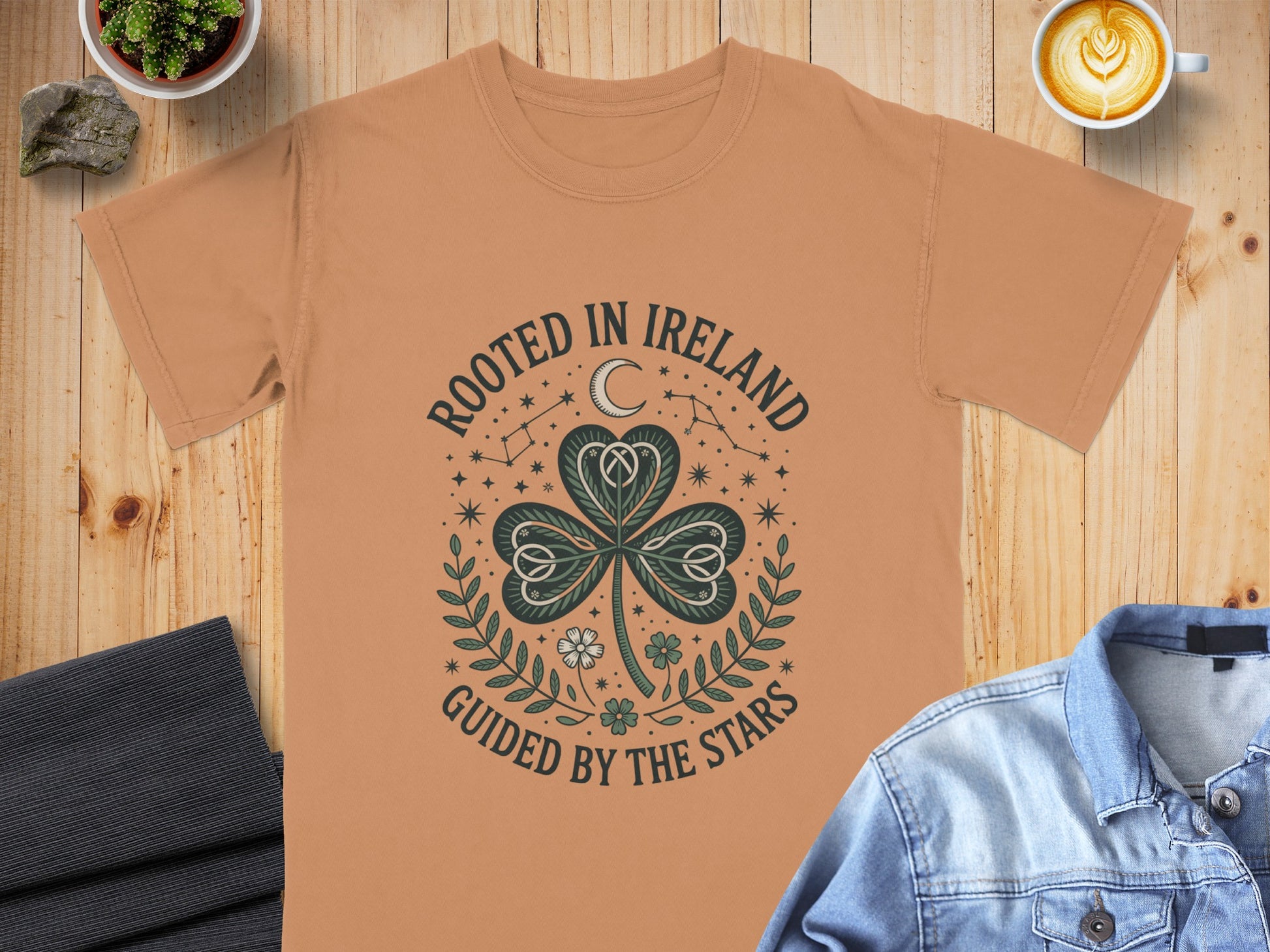 T-shirt with "Rooted in Ireland, Guided by the Stars" text and shamrock design.