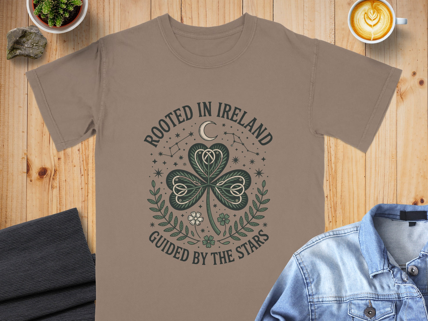 Brown t-shirt with "Rooted in Ireland, Guided by the Stars" text and shamrock design.
