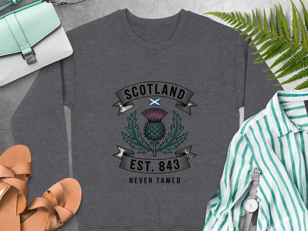Dark gray sweatshirt with Scotland thistle design, "EST. 843 NEVER TAMED".