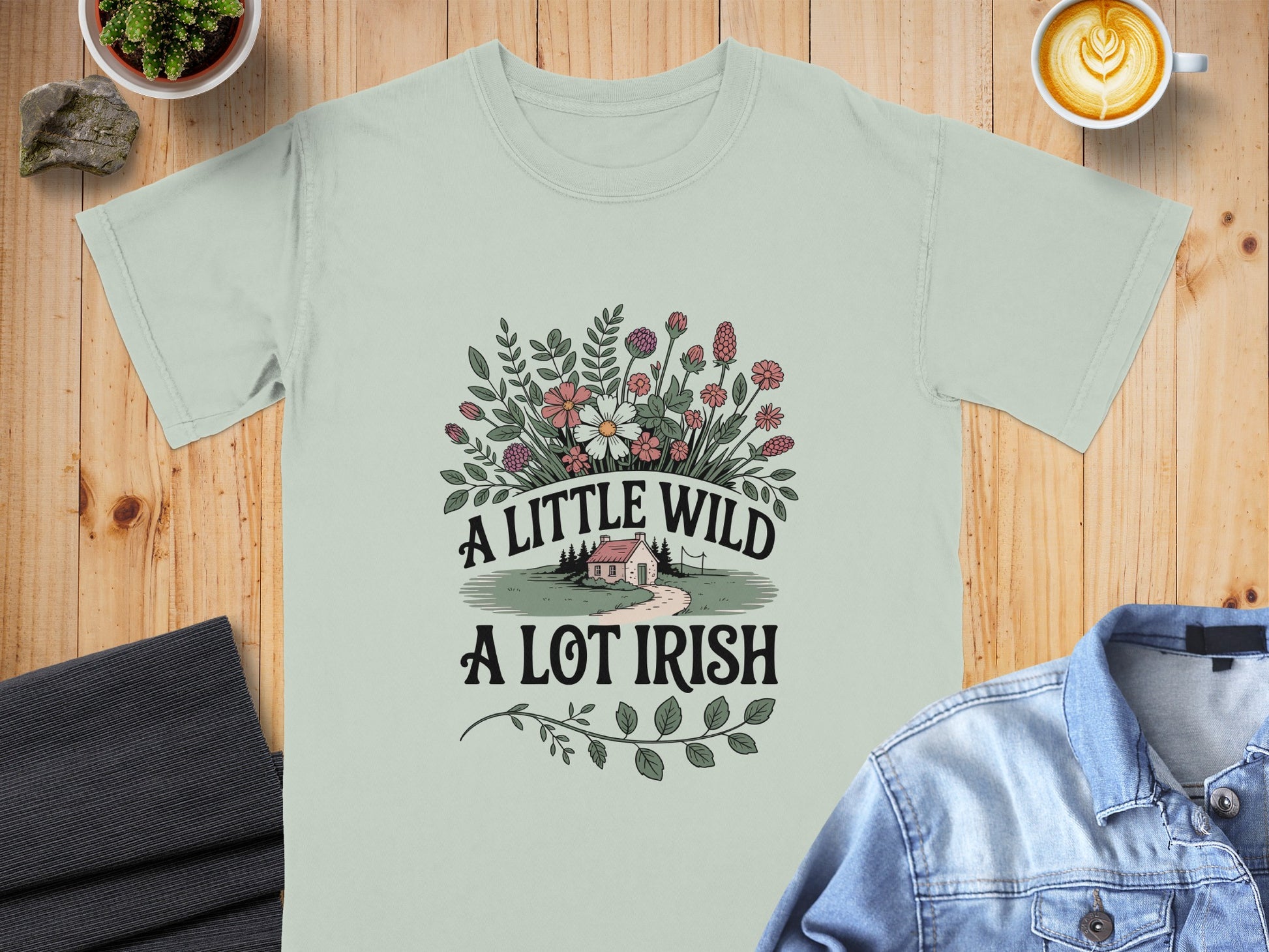 Light green t-shirt with "A LITTLE WILD A LOT IRISH" text, floral design, and small house.