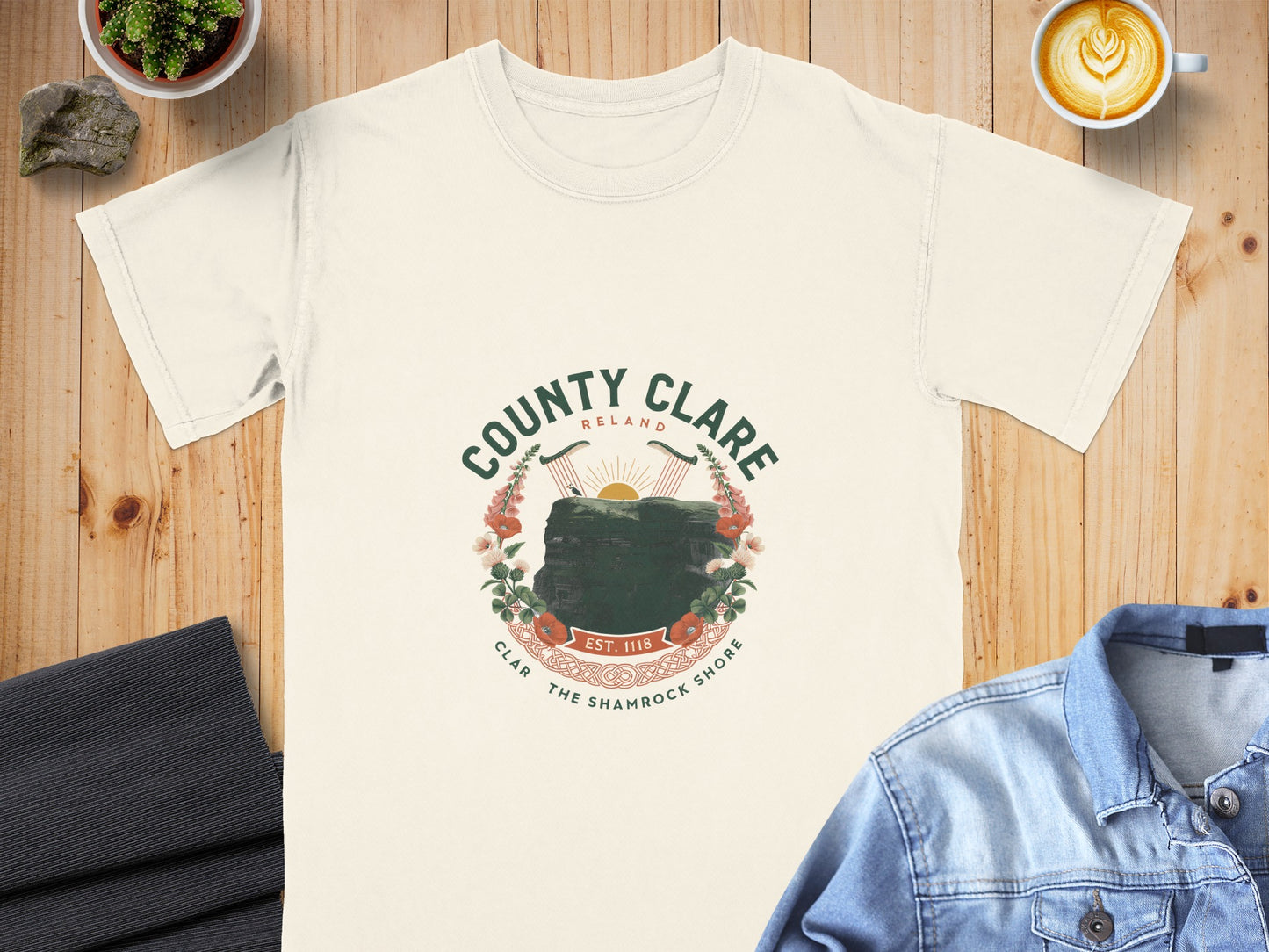 Cream t-shirt with "County Clare Ireland" crest featuring cliffs, harps, flowers, and "Est. 1118".
