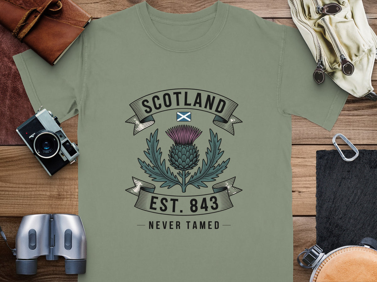 T-shirt with Scotland emblem, thistle, and "Never Tamed" text.