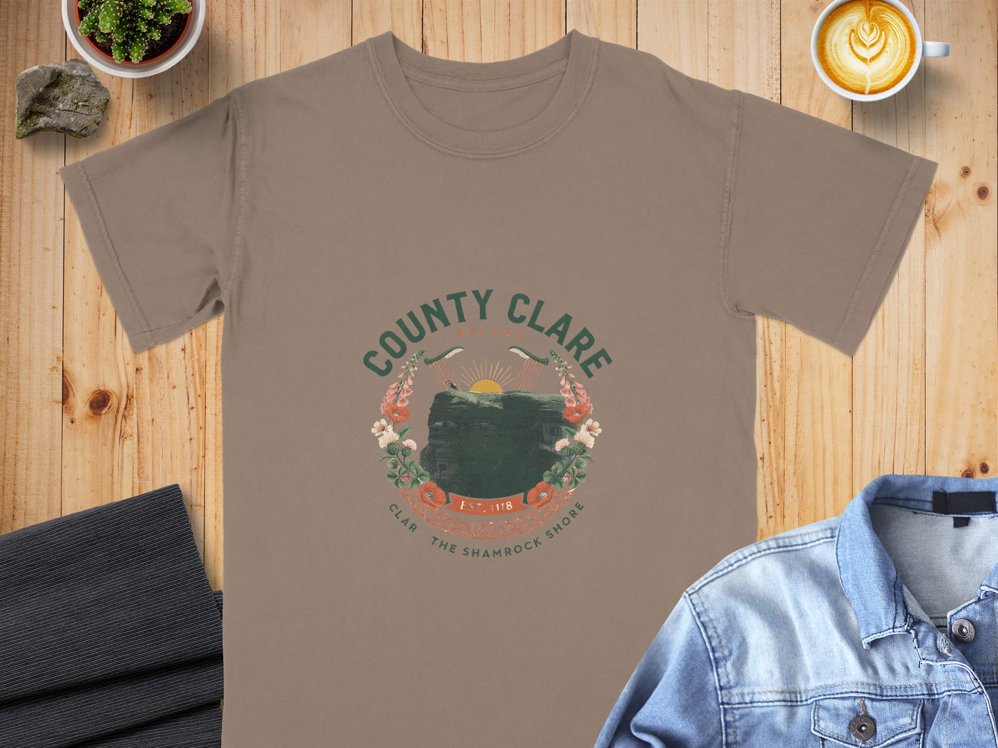 Taupe t-shirt with "County Clare Ireland" graphic featuring cliffs, harps, and flowers.