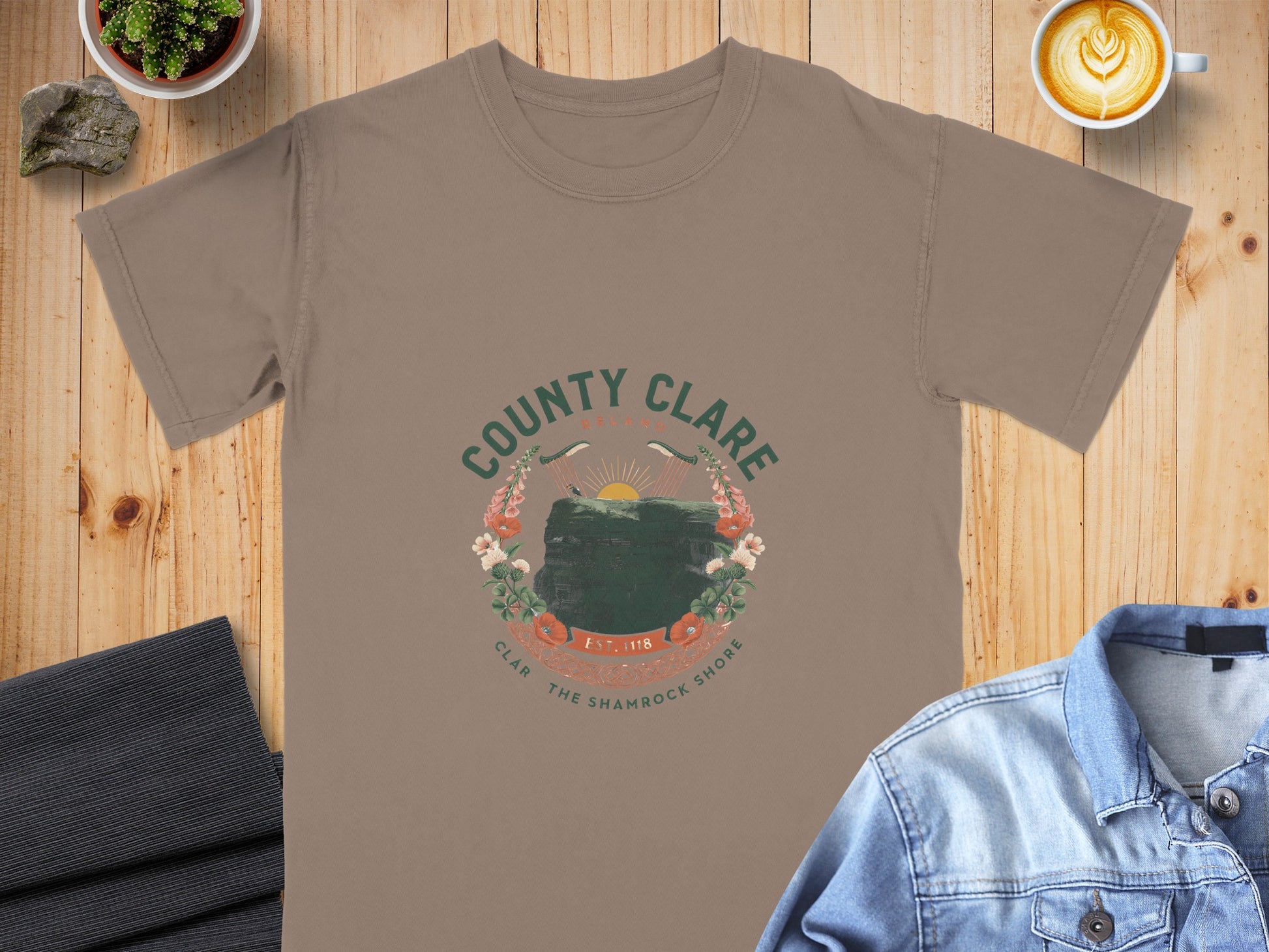 Taupe t-shirt with "County Clare Ireland" graphic featuring cliffs, harps, and flowers.