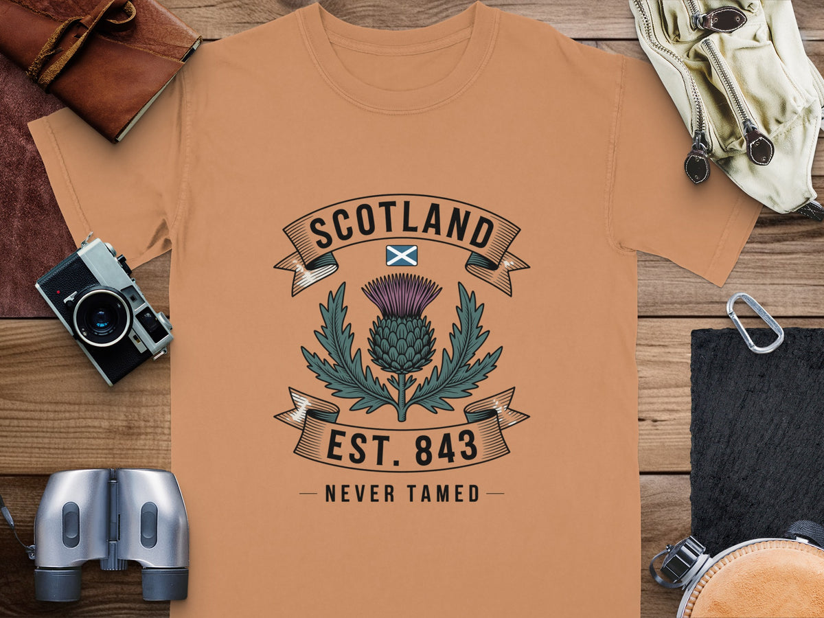 Orange t-shirt with Scotland, Scottish thistle, and "Est. 843 Never Tamed" graphic.