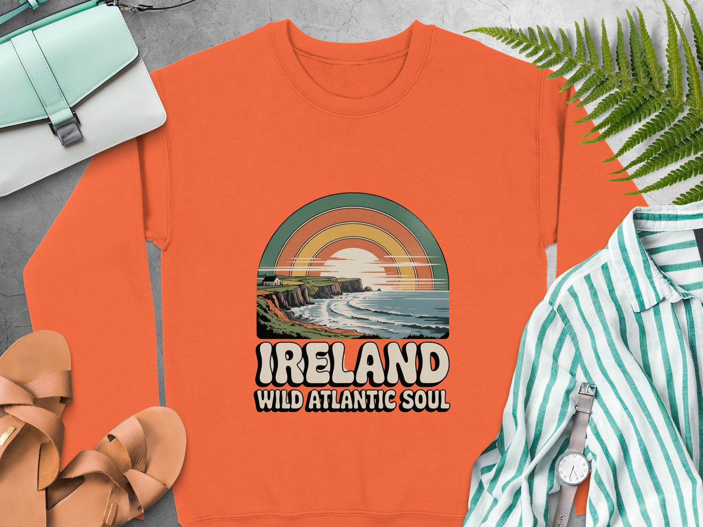 Orange sweatshirt with "IRELAND WILD ATLANTIC SOUL" text and coastal graphic.