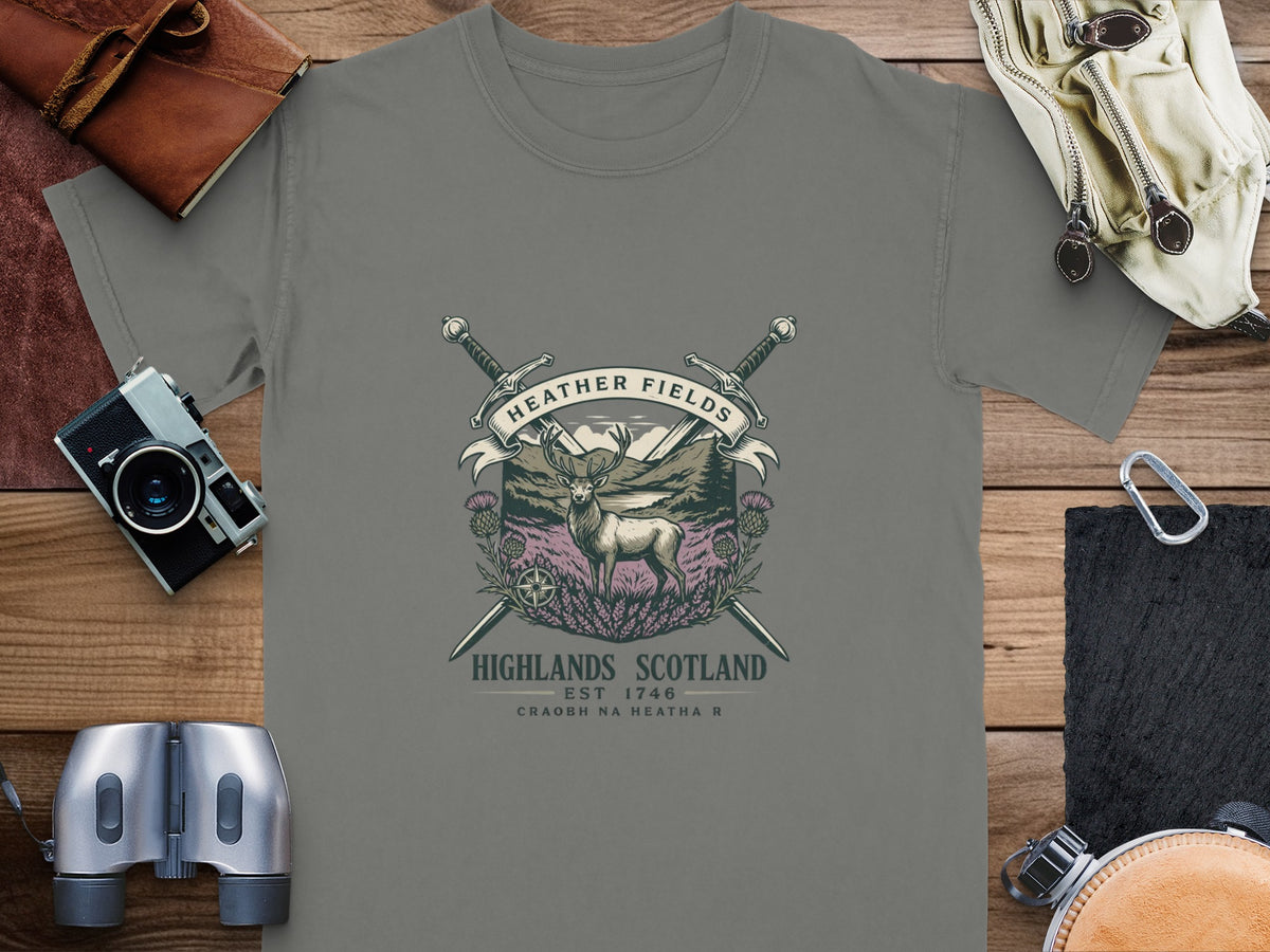 T-shirt with a deer, crossed swords, thistles, and text "Heather Fields Highlands Scotland".